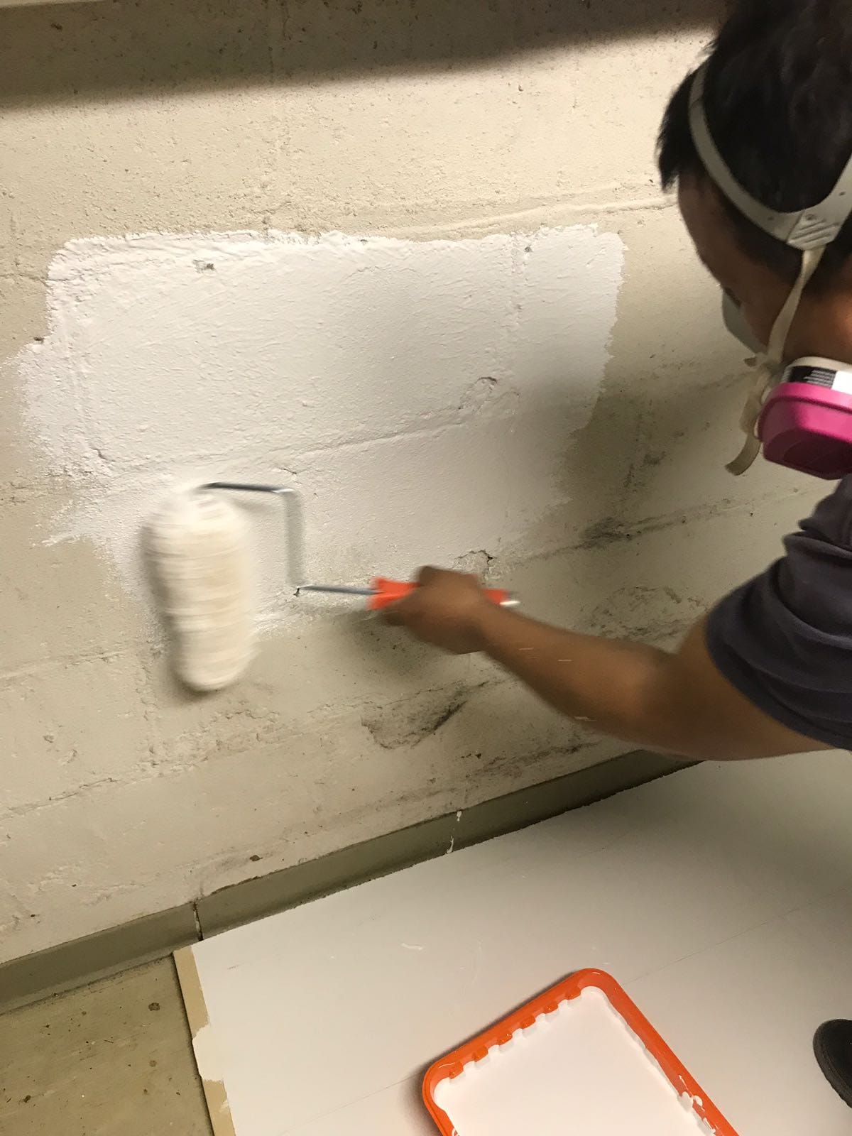 applying waterproofing paint to basement