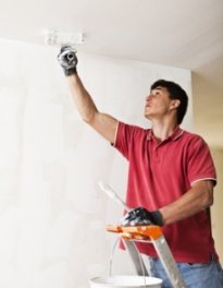 Man painting ceiling using paint for mold